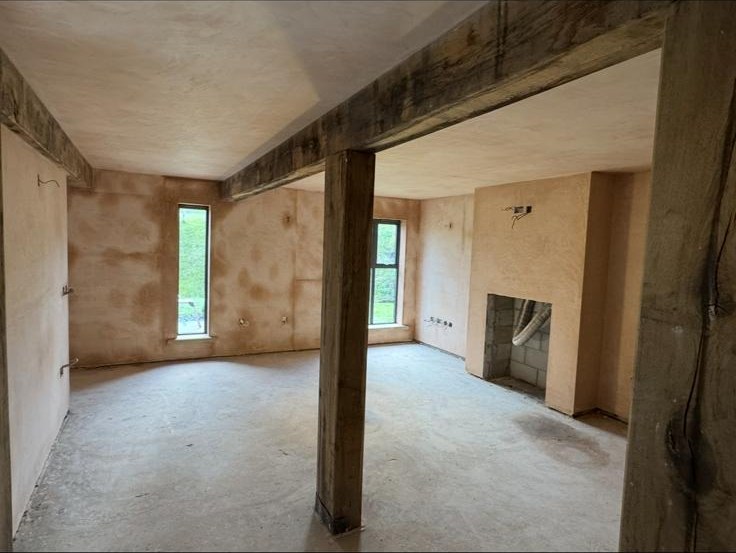 Interior reception room freshly skimmed in pink plaster by MCB — feature window reveal finished crisply